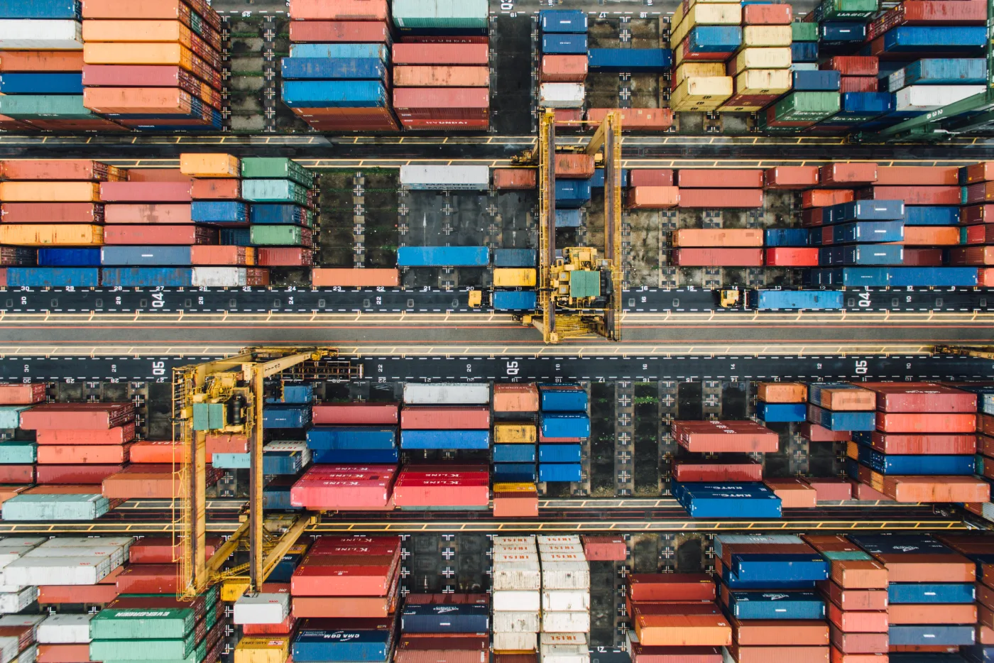 An aerial view of shipping containers and gantry cranes at a terminal in Singapore